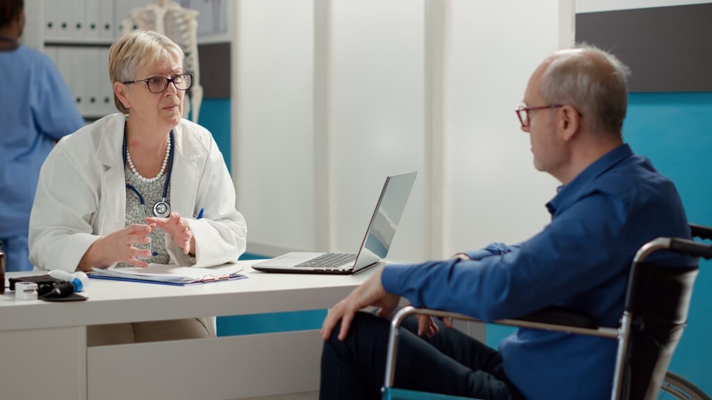 Female physician consulting man with chronic disability