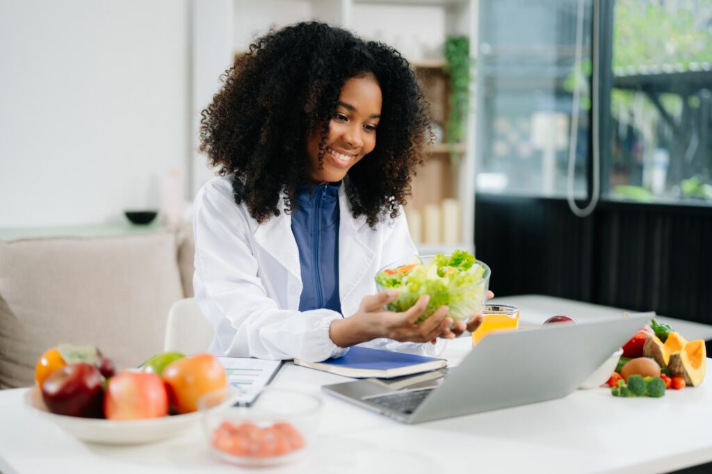 Professional nutritionist reviewing fresh vegetables and supplements for diet planning, health care
